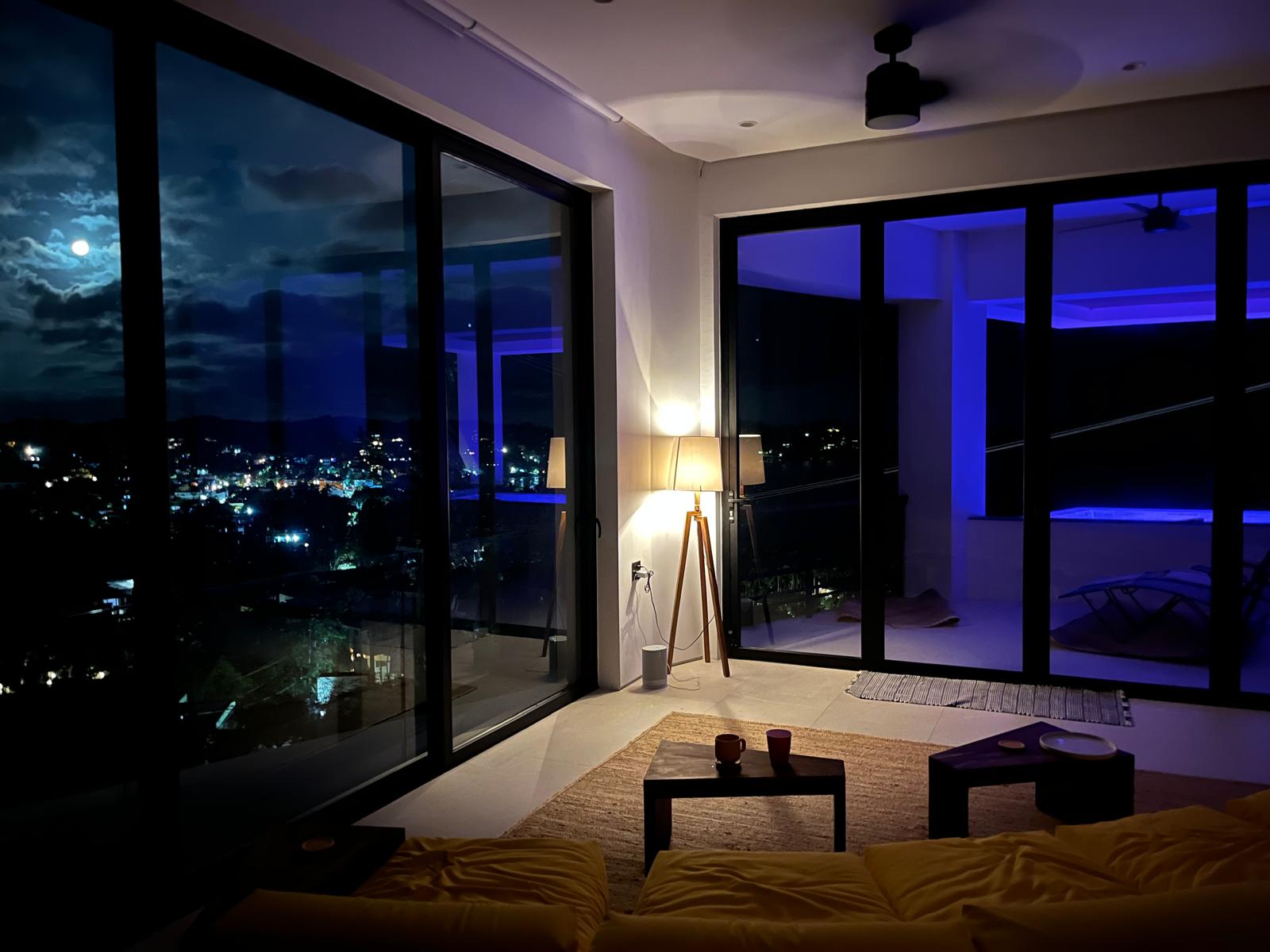 Living room at night with moonlight over Sayulita's town lights